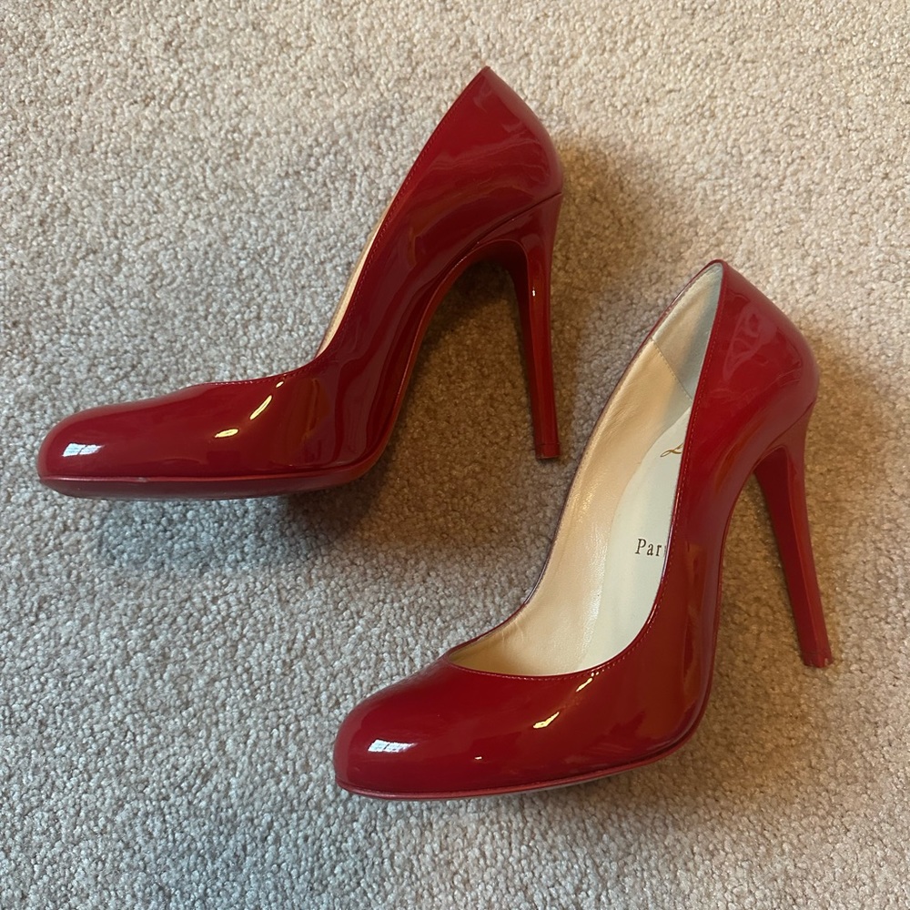 Red patent round toe Louboutin pumps